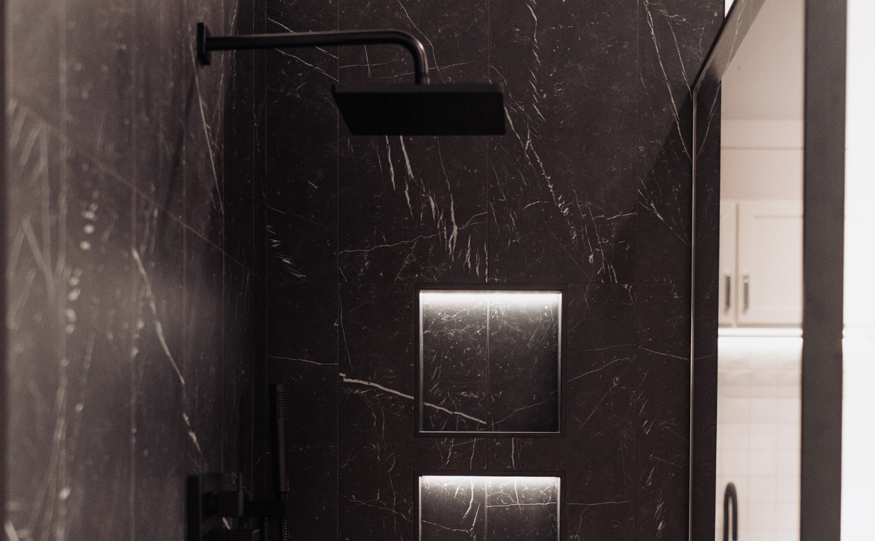 Black wall tiled walk-in shower display at D&M Interiors Kiba Studios