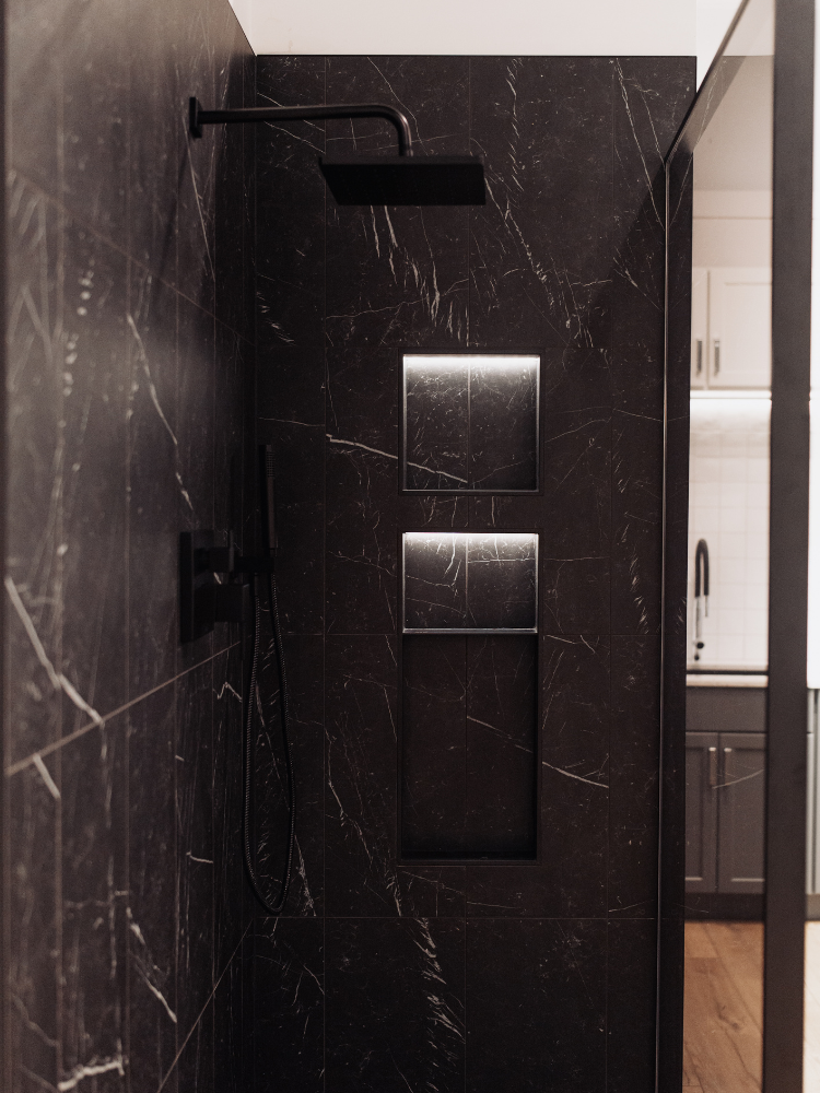 Black wall tiled walk-in shower display at D&M Interiors Kiba Studios