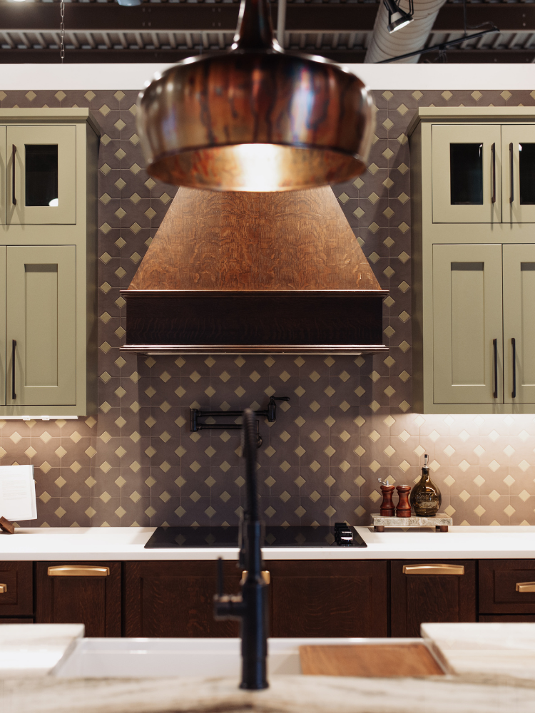 Green, white and brown cabinets in a kiba kitchen display at D&M Interiors
