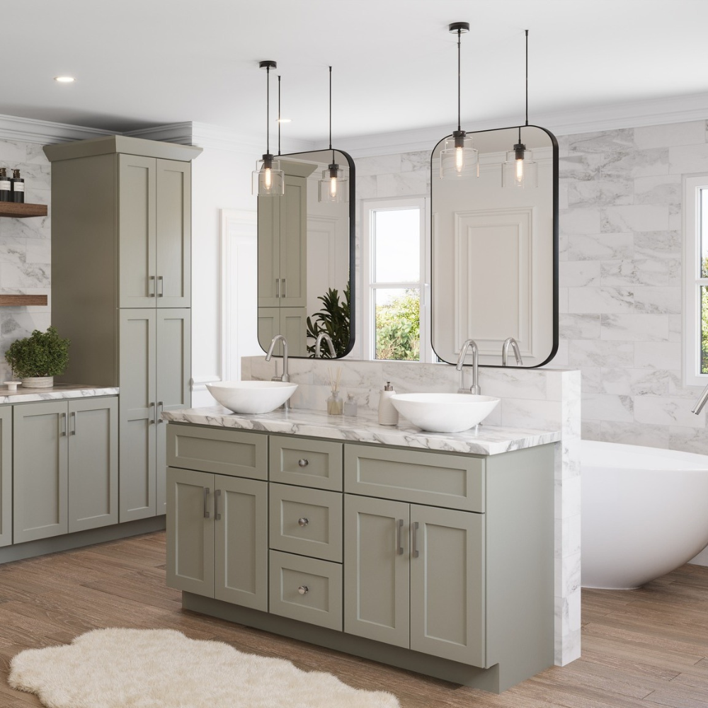 Pendant lights in front of a vanity with green cabinetry in a bathroom