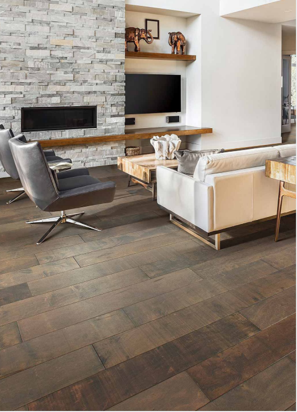 Dark hardwood planking in contemporary living room, featuring stone fire place and furniture.